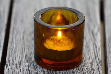 Decoration of Candle set in the glass, with blur background of wooden table