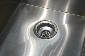 close up on stainless steel drain in kitchen sink - obrazy, fototapety, plakaty