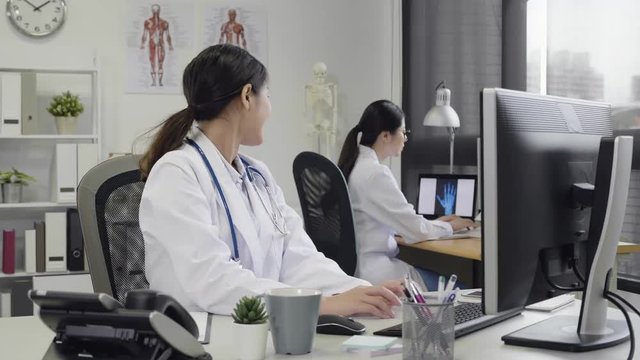 Group of women doctors show cheerful confirm sign with hands raised up. High level therapy best consultation physical. female medical staff show computer screen to coworker smiling joyful done work