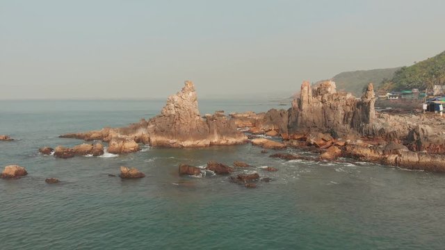 Aerial view rocks and stones on the Arambol beach in North Goa, India.