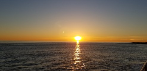 Sun melting into ocean