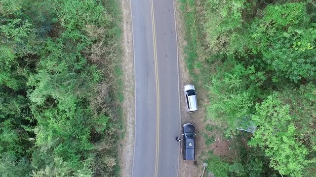 hill freeway aerial image with skater getting out of the car and doing tricks