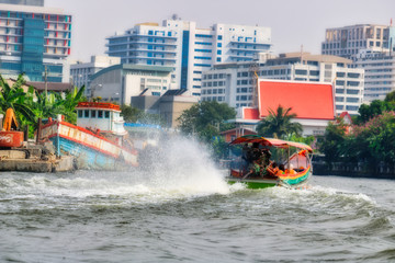 Fototapeta premium Dieses einzigartige Foto zeigt wie die alten traditionellen Langheckboote, die auf dem Fluss Mae Nam Chao Phraya in Bangkok fahren