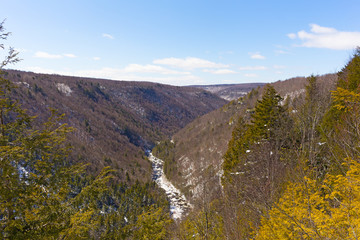 Blackwater River runs in canyon in West Virginia, USA.  Countryside winter landscape with forests and mountains.