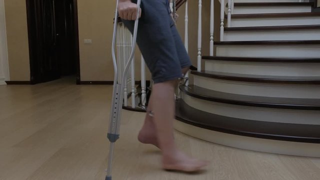 Climbing the stairs on crutches with a broken leg in the Ilizarov's external fixator