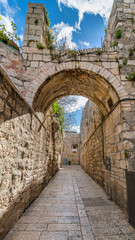 Fototapeta na wymiar Ancient narrow street in old city of Jerusalem that is considered holy to the three major religions — Judaism, Christianity, and Islam, Israel