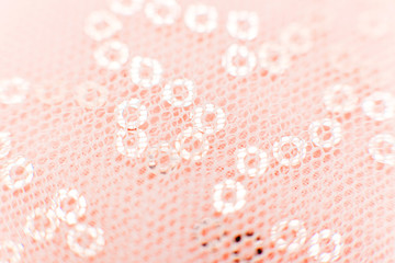 mesh fabric texture with sequins Texture cloth mesh. Pink shiny mesh fabric close-up. Beautiful and original background or texture.