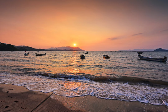 Beautiful sunset and soft waves over the beach in Langkawi island, malaysia