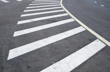 crosswalk on the road for safety when people walking cross the street, Pedestrian crossing on a repaired asphalt road, Crosswalk on the street for safety. 