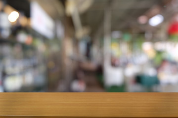 Empty dark wooden table in front of abstract blurred bokeh background of restaurant . can be used for display or montage your products.Mock up for space.