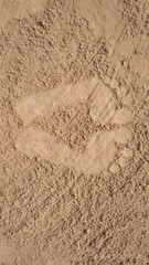 Footprints of human on the sand of a sea.