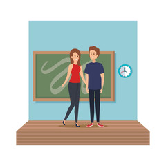 young teachers couple with chalkboard in classroom scene
