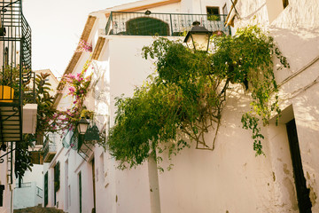 Beautiful narrow street in the old town with white houses and a cobblestone road. Altea, Spain