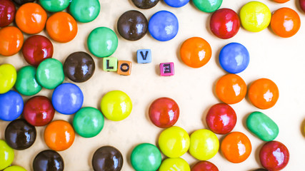 Close up a pile of colorful chocolate coated candy, chocolate background.Sweet and love sign