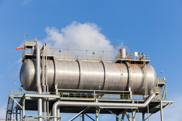 Hot oil drum. Petrochemical oil refinery factory plant. Blue Sky. Wind Sock.