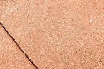 Old asphalt surface texture background close up. Orange color toned