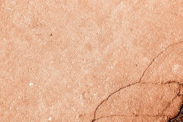 Old asphalt surface texture background close up. Orange color toned