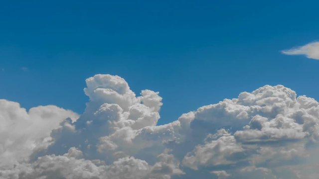 Cumulus clouds boil. Time lapse. At rigth bottom corner smoke from wildfire