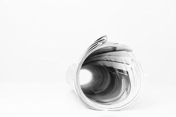 newspaper rolled up and sitting on a table