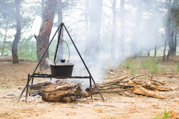 Cooking food on the fire in the pot.