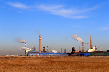 Fototapeta na wymiar A chemical plant against a blue sky