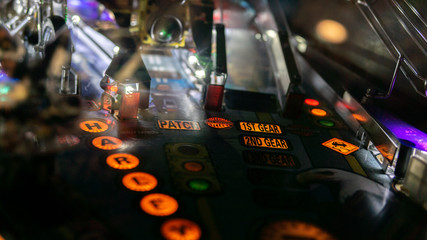 Fototapeta na wymiar Pinball machine in a dark room