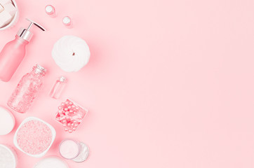 Girlish cute cosmetic products for bath on pastel pink background, top view, copy space.