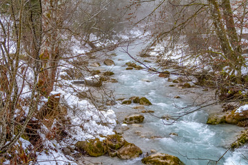 Fototapeta na wymiar alpine stream at winter time