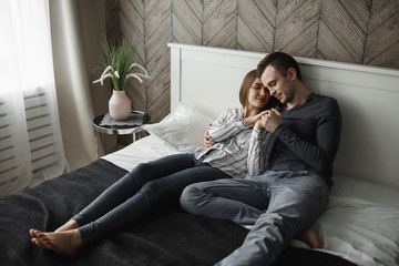 Fototapeta premium girl relaxes with her boyfriend on the bed