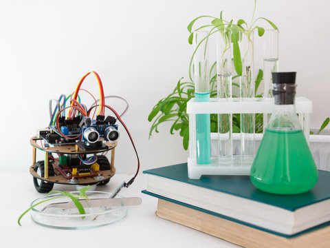 Robot handmade in the laboratory. Here are the plants, test tubes, microscope all around. STEM and STEAM education. An experiment in biology, robotics, chemistry, physics and mathematics.