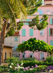 Pink house with mint shutters on the street of Menton, Cot d'Azur, France