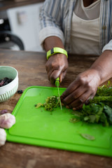 Focused photo on international woman that cooking salad
