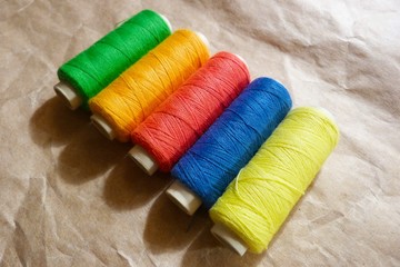 bright fablue silk foldclose-up bobbins with threads stripes abstraction natural fabric ice color texture backgroundbric tropical pattern abstraction blue red yellow green decor background