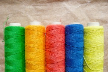 bright fablue silk foldclose-up bobbins with threads stripes abstraction natural fabric ice color texture backgroundbric tropical pattern abstraction blue red yellow green decor background