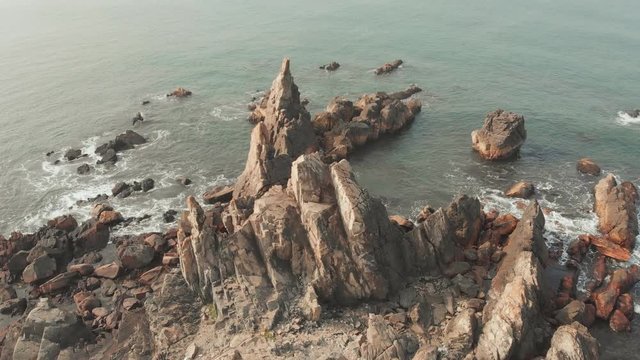 Aerial view rocks and stones on the Arambol beach in North Goa, India.