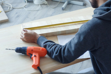 Engineer working on house or apartment renovation with blueprint. Construction concept. Engineering tools.