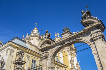 Fototapeta na wymiar Double parade gate with baroque pediment and figures of saints to Lviv Greek Catholic Archbishop's Cathedral of Saint George (Ukr: Sobor sviatoho Yura, 1760). Lviv, Ukraine.