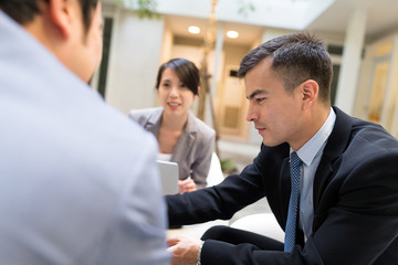 Business people discuss on report