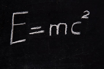The formula of the law of conservation of energy on the chalk board.