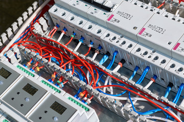 Laying of electrical wires in a perforated cable channel, connection to circuit breakers, contactors, controllers with display in the electrical Cabinet. Connection of wires according to the scheme.
