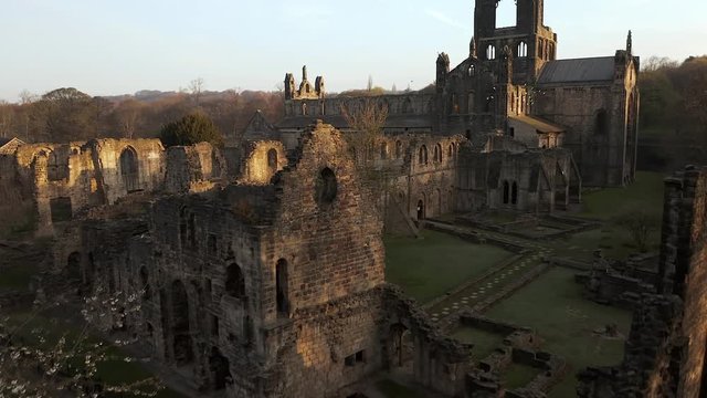 Aerial Flyover of Kirkstall Abbey in Yorkshire, England at Dawn on Sunny Spring Day