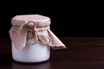  yogurt on a dark wooden background. Farm natural products.