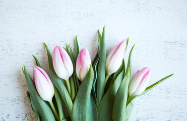 Bunch of pink tulips bouquet on wood white table