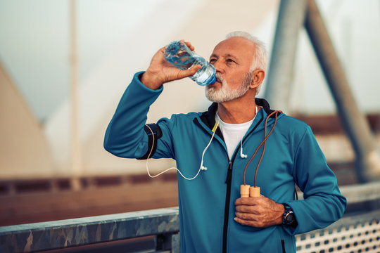 Active senior man practicing jogging in the city
