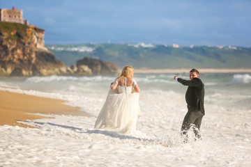 Beautiful wedding couple posing on beach