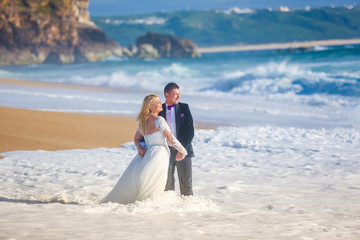 Beautiful wedding couple posing on beach
