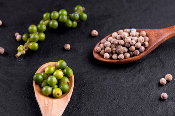 Farm fresh green peppercorns isolated on wood
