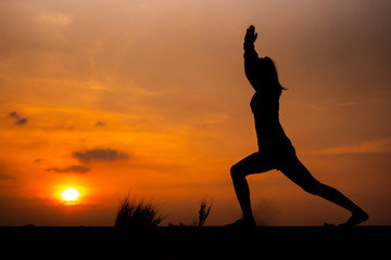 Fototapeta na wymiar Silhouette Asia woman yoga on sunset. - Image