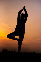 Silhouette Asia woman yoga on sunset. - Image