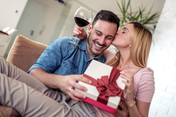 Husband making surprise to wife, giving gift box